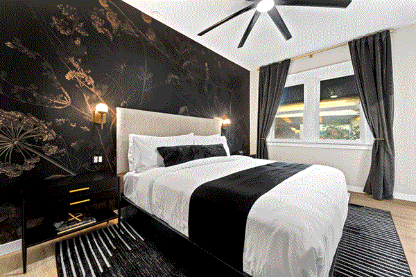 Signature King bedroom with black and white bed in a sleek modern setting in San Diego, CA.